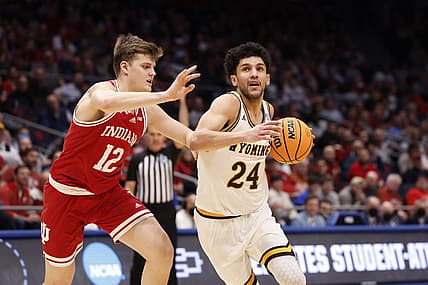 Mar 15, 2022; Dayton, OH, USA; Wyoming Cowboys guard Hunter Maldonado (24) looks to move the ball defended by Indiana Hoosiers forward Miller Kopp (12) in the second half during the First Four of the 2022 NCAA Tournament at UD Arena. Mandatory Credit: Rick Osentoski-USA TODAY Sports
