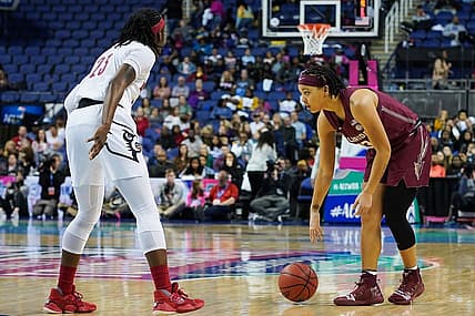 Mar 7, 2020; Greensboro, North Carolina, USA; Florida State Seminoles guard Nausia Woolfolk (13) handles the ball against Louisville Cardinals guard Jazmine Jones (23)  during the first half at Greensboro Coliseum. Mandatory Credit: Jim Dedmon-USA TODAY Sports