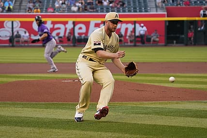 May 6, 2022; Phoenix, Arizona, USA; Arizona Diamondbacks starting pitcher Merrill Kelly (29) fields a ball against the Colorado Rockies during the first inning at Chase Field. Mandatory Credit: Joe Camporeale-USA TODAY Sports