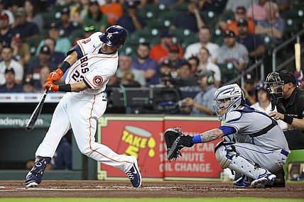 Jun 22, 2022; Houston, Texas, USA; Houston Astros designated hitter Michael Brantley (23) hits an RBI double against the New York Mets in the first inning at Minute Maid Park. Mandatory Credit: Thomas Shea-USA TODAY Sports
