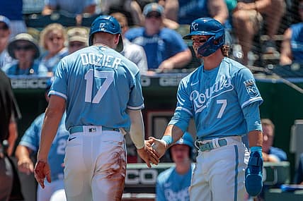 Jun 29, 2022; Kansas City, Missouri, USA; Kansas City Royals shortstop Bobby Witt Jr. (7) slaps hands with Kansas City Royals first baseman Hunter Dozier (17) after scoring during the first inning against the Texas Rangers at Kauffman Stadium. Mandatory Credit: William Purnell-USA TODAY Sports