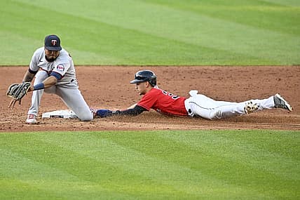Jun 29, 2022; Cleveland, Ohio, USA; Cleveland Guardians left fielder Steven Kwan (38) steals second base beside Minnesota Twins shortstop Jorge Polanco (11) in the third inning at Progressive Field. Mandatory Credit: David Richard-USA TODAY Sports