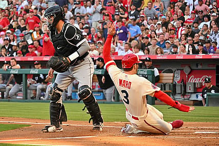 Jun 29, 2022; Anaheim, California, USA; Los Los Angeles Angels right fielder Taylor Ward (3) scores past Chicago White Sox catcher Reese McGuire (21) on a double hit by Los Angeles Angels center fielder Mike Trout (not pictured) in the first inning at Angel Stadium. Mandatory Credit: Jayne Kamin-Oncea-USA TODAY Sports