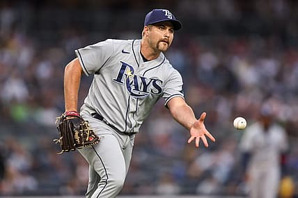 Jun 16, 2022; Bronx, New York, USA; Tampa Bay Rays starting pitcher Jalen Beeks (68) tosses the ball to first base for an out during the first inning against the New York Yankees at Yankee Stadium. Mandatory Credit: Vincent Carchietta-USA TODAY Sports