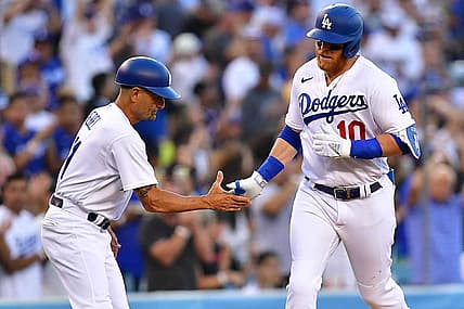 Jun 30, 2022; Los Angeles, California, USA; Los Angeles Dodgers third baseman Justin Turner (10) is greeted by third base coach Dino Ebel (91) after hitting a solo home run against the San Diego Padres during the second inning at Dodger Stadium. Mandatory Credit: Gary A. Vasquez-USA TODAY Sports