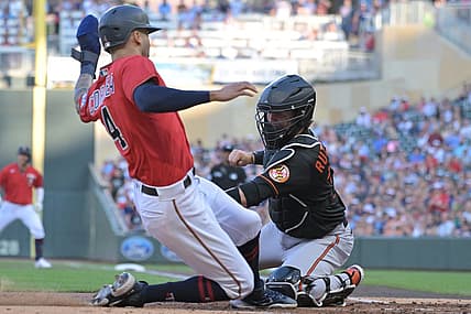 Jul 1, 2022; Minneapolis, Minnesota, USA; Baltimore Minnesota Twins shortstop Carlos Correa (4) is tagged out at home by Baltimore Orioles catcher Adley Rutschman (35) on an RBI single by Minnesota Twins first baseman Jose Miranda (not pictured) during the first inning at Target Field. Mandatory Credit: Jeffrey Becker-USA TODAY Sports