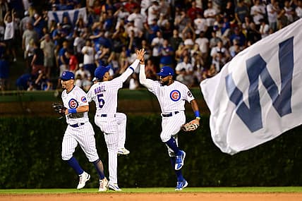 Jul 2, 2022; Chicago, Illinois, USA; Chicago Cubs left fielder Ian Happ (8), Chicago Cubs center fielder Narciso Crook (24), and Chicago Cubs center fielder Christopher Morel (5) celebrate after the 3-1 win against the Boston Red Sox at Wrigley Field. Mandatory Credit: Quinn Harris-USA TODAY Sports