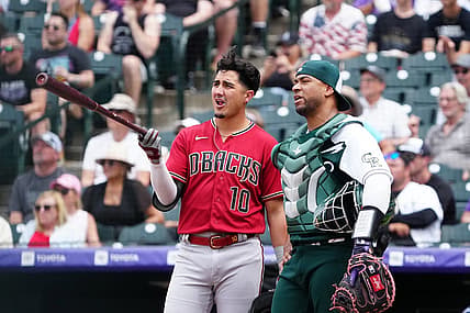 Jul 3, 2022; Denver, Colorado, USA; Arizona Diamondbacks third baseman Josh Rojas (10) and Colorado Rockies catcher Elias Diaz (35) talks during a review in the sixth inning at Coors Field. Mandatory Credit: Ron Chenoy-USA TODAY Sports