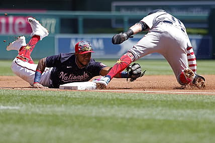 Jul 4, 2022; Washington, District of Columbia, USA; Miami Marlins shortstop Miguel Rojas (11) is tagged out by Washington Nationals third baseman Maikel Franco (7) while attempting to advance to third base on a single by Marlins third baseman Brian Anderson (not pictured) during the first inning at Nationals Park. Mandatory Credit: Geoff Burke-USA TODAY Sports
