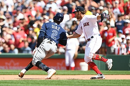 Jul 4, 2022; Boston, Massachusetts, USA; Boston Red Sox pitcher Kutter Crawford (50) tags out Tampa Bay Rays third baseman Yandy Diaz (2) during the fifth inning at Fenway Park. Mandatory Credit: Brian Fluharty-USA TODAY Sports