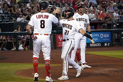 Jul 4, 2022; Phoenix, Arizona, USA; Arizona Diamondbacks left fielder Cooper Hummel (21) and right fielder Jordan Luplow (8) slap hands after scoring run against the San Francisco Giants during the first inning at Chase Field. Mandatory Credit: Joe Camporeale-USA TODAY Sports