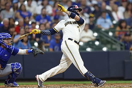 Jul 4, 2022; Milwaukee, Wisconsin, USA;  Milwaukee Brewers catcher Victor Caratini (7) hits a three run home run during the tenth inning against the Chicago Cubs at American Family Field. Mandatory Credit: Jeff Hanisch-USA TODAY Sports