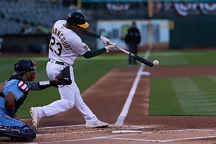Jul 5, 2022; Oakland, California, USA; Oakland Athletics first baseman Christian Bethancourt (23) hits a RBI single during the first inning against the Toronto Blue Jays at RingCentral Coliseum. Mandatory Credit: Stan Szeto-USA TODAY Sports