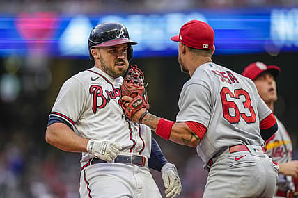 Jul 7, 2022; Cumberland, Georgia, USA; Atlanta Braves left fielder Adam Duvall (14) is tagged out in a run down by St. Louis Cardinals shortstop Edmundo Sosa (63) during the second inning at Truist Park. Mandatory Credit: Dale Zanine-USA TODAY Sports