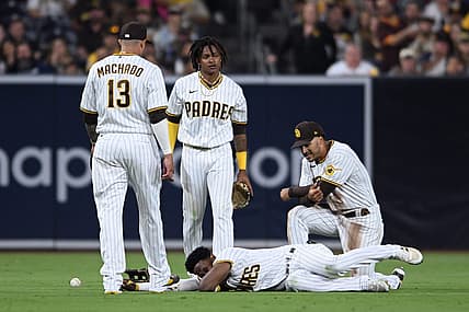 Jul 7, 2022; San Diego, California, USA; San Diego Padres shortstop baseman C.J. Abrams (top, center) and left fielder Jurickson Profar (bottom) react after colliding during the fifth inning against the San Francisco Giants at Petco Park. Mandatory Credit: Orlando Ramirez-USA TODAY Sports