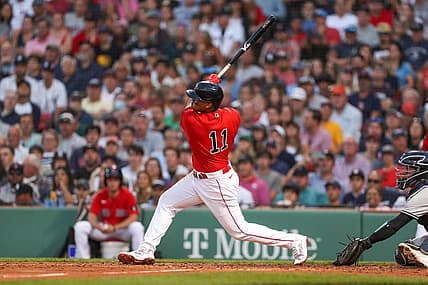 Jul 7, 2022; Boston, Massachusetts, USA; Boston Red Sox third baseman Rafael Devers (11) hits a home run during the third inning against the New York Yankees at Fenway Park. Mandatory Credit: Paul Rutherford-USA TODAY Sports