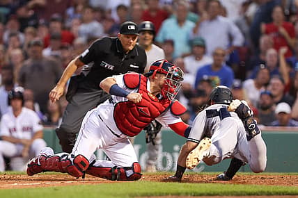 Jul 8, 2022; Boston, Massachusetts, USA; New York Yankees right fielder Joey Gallo (13) is tagged out at home by Boston Red Sox catcher Christian Vazquez (7) during the third inning at Fenway Park. Mandatory Credit: Paul Rutherford-USA TODAY Sports