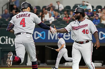 Jul 8, 2022; Arlington, Texas, USA; Minnesota Twins shortstop Carlos Correa (4) celebrates with third base coach Tommy Watkins (40) after hitting a two run home run against the Texas Rangers during the first inning at Globe Life Field. Mandatory Credit: Jim Cowsert-USA TODAY Sports