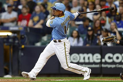 Jul 8, 2022; Milwaukee, Wisconsin, USA;  Milwaukee Brewers right fielder Jace Peterson (14) hits an RBI single during the fourth inning against the Pittsburgh Pirates at American Family Field. Mandatory Credit: Jeff Hanisch-USA TODAY Sports