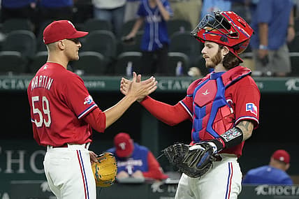 Jul 8, 2022; Arlington, Texas, USA; Texas Rangers relief pitcher Brett Martin (59) and catcher Jonah Heim (28) celebrate after defeating the Minnesota Twins at Globe Life Field. The Rangers won 6-5. Mandatory Credit: Jim Cowsert-USA TODAY Sports