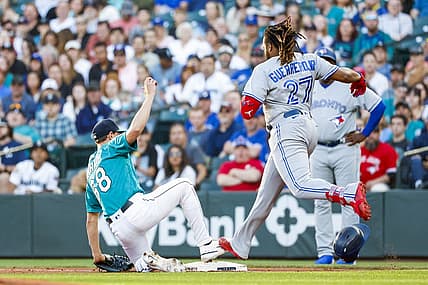 Jul 8, 2022; Seattle, Washington, USA; Seattle Mariners starting pitcher George Kirby (68) steps on first base before Toronto Blue Jays designated hitter Vladimir Guerrero Jr. (27) for a groundout during the third inning at T-Mobile Park. Mandatory Credit: Joe Nicholson-USA TODAY Sports