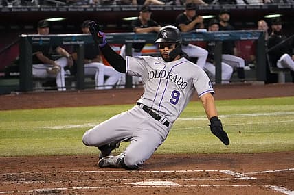 Jul 9, 2022; Phoenix, Arizona, USA; Colorado Rockies left fielder Connor Joe (9) slides and scores a run against the Arizona Diamondbacks during the third inning at Chase Field. Mandatory Credit: Joe Camporeale-USA TODAY Sports