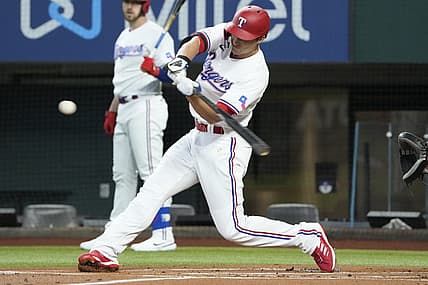 Jul 9, 2022; Arlington, Texas, USA; Texas Rangers shortstop Corey Seager (5) hits for a single against the Minnesota Twins during the first inning at Globe Life Field. Mandatory Credit: Jim Cowsert-USA TODAY Sports