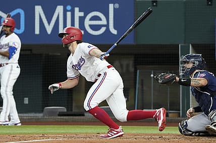 Jul 9, 2022; Arlington, Texas, USA; Texas Rangers third baseman Charlie Culberson (11) follows through on his single against the Minnesota Twins during the second inning at Globe Life Field. Mandatory Credit: Jim Cowsert-USA TODAY Sports