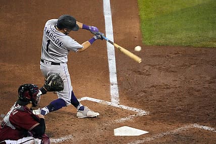 Jul 10, 2022; Phoenix, Arizona, USA; Colorado Rockies center fielder Garrett Hampson (1) hits a two-run RBI double against the Arizona Diamondbacks during the seventh inning at Chase Field. Mandatory Credit: Joe Camporeale-USA TODAY Sports