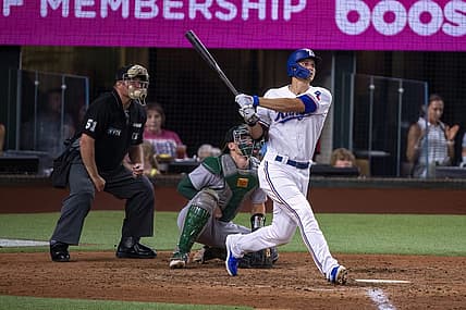 Jul 11, 2022; Arlington, Texas, USA; Texas Rangers shortstop Corey Seager (5) hits a home run against the Oakland Athletics during the fifth inning at Globe Life Field. Mandatory Credit: Jerome Miron-USA TODAY Sports