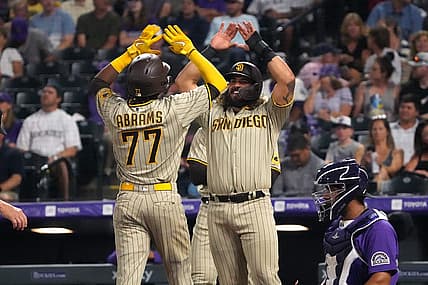 Jul 11, 2022; Denver, Colorado, USA; San Diego Padres shortstop C.J. Abrams (77) celebrates his three-run home run with catcher Jorge Alfaro (38) in the seventh inning against the Colorado Rockies at Coors Field. Mandatory Credit: Ron Chenoy-USA TODAY Sports