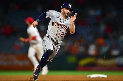 Jul 12, 2022; Anaheim, California, USA; Houston Astros second baseman Jose Altuve (27) runs to third against the Los Angeles Angels during the ninth inning at Angel Stadium. Mandatory Credit: Gary A. Vasquez-USA TODAY Sports