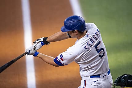Jul 13, 2022; Arlington, Texas, USA; Texas Rangers designated hitter Corey Seager (5) drives in a run against the Oakland Athletics during the first inning at Globe Life Field. Mandatory Credit: Jerome Miron-USA TODAY Sports