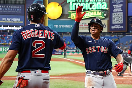 Jul 14, 2022; St. Petersburg, Florida, USA;  Boston Red Sox third baseman Rafael Devers (11) is congratulated by shortstop Xander Bogaerts (2) after hitting a home run against the Tampa Bay Rays in the fourth inning at Tropicana Field. Mandatory Credit: Nathan Ray Seebeck-USA TODAY Sports