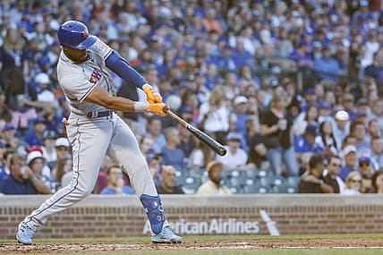 Jul 14, 2022; Chicago, Illinois, USA; New York Mets right fielder Starling Marte (6) hits an RBI-single against the Chicago Cubs during the second inning at Wrigley Field. Mandatory Credit: Kamil Krzaczynski-USA TODAY Sports