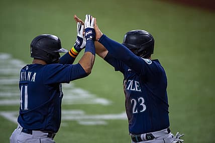 Jul 16, 2022; Arlington, Texas, USA; Seattle Mariners designated hitter Carlos Santana (41) and first baseman Ty France (23) celebrate the two run home run hit by Santana against the Texas Rangers during the third inning at Globe Life Field. Mandatory Credit: Jerome Miron-USA TODAY Sports
