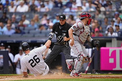 Jul 17, 2022; Bronx, New York, USA; New York Yankees second baseman DJ LeMahieu (26) scores a run on an errant throw to Boston Red Sox catcher Christian Vazquez (7) during the first inning at Yankee Stadium. Mandatory Credit: Gregory Fisher-USA TODAY Sports