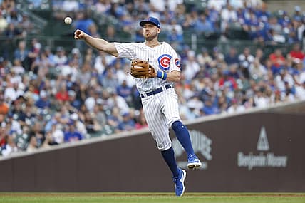 Jul 17, 2022; Chicago, Illinois, USA; Chicago Cubs third baseman Patrick Wisdom (16) throws to first base for a New York Mets out during the fourth inning at Wrigley Field. Mandatory Credit: Kamil Krzaczynski-USA TODAY Sports