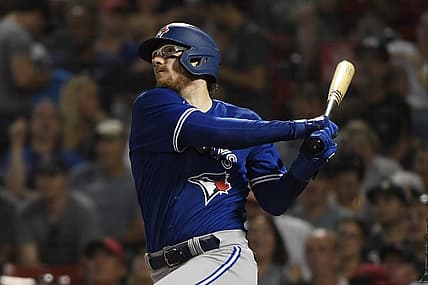 Jul 22, 2022; Boston, Massachusetts, USA;  Toronto Blue Jays catcher Danny Jansen (9) hits a home run during the fourth inning against the Boston Red Sox at Fenway Park. Mandatory Credit: Bob DeChiara-USA TODAY Sports