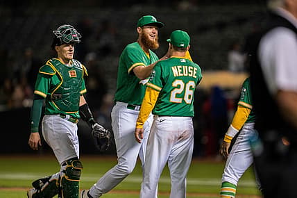 Jul 22, 2022; Oakland, California, USA;  Oakland Athletics relief pitcher A.J. Puk (33) celebrates with Oakland Athletics designated hitter Sheldon Neuse (26) after the game against the Texas Rangers at RingCentral Coliseum. Mandatory Credit: Neville E. Guard-USA TODAY Sports