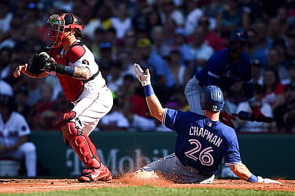 Jul 23, 2022; Boston, Massachusetts, USA; Toronto Blue Jays third baseman Matt Chapman (26) slides safely into home scoring a run in front of Boston Red Sox catcher Christian Vazquez (7) during the third inning at Fenway Park. Mandatory Credit: Brian Fluharty-USA TODAY Sports