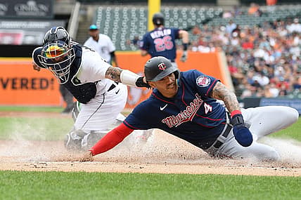 Jul 24, 2022; Detroit, Michigan, USA; Minnesota Twins shortstop Carlos Correa (4) slides safely into home plate ahead of the tag of Detroit Tigers catcher Eric Haase (13) on a fielder s choice hit by right fielder Max Kepler (not pictured) during the first inning at Comerica Park. Mandatory Credit: Lon Horwedel-USA TODAY Sports