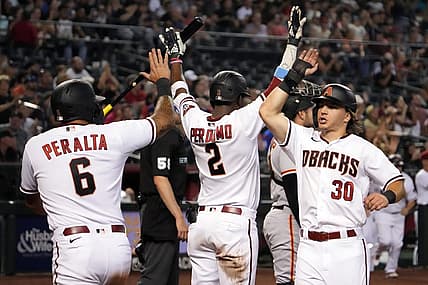 Jul 25, 2022; Phoenix, Arizona, USA; Arizona Diamondbacks designated hitter David Peralta (6) and left fielder Jake McCarthy (30) celebrate with shortstop Geraldo Perdomo (2) after scoring runs against the San Francisco Giants during the sixth inning at Chase Field. Mandatory Credit: Joe Camporeale-USA TODAY Sports