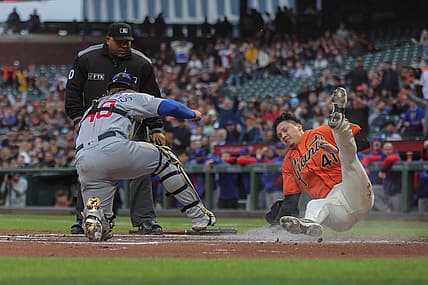 Jul 29, 2022; San Francisco, California, USA;  San Francisco Giants third baseman Wilmer Flores (41) gets tagged out at home plate by Chicago Cubs catcher Willson Contreras (40) during the first inning at Oracle Park. Mandatory Credit: Sergio Estrada-USA TODAY Sports