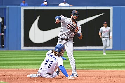 Jul 31, 2022; Toronto, Ontario, CAN; Detroit Tigers second base Willi Castro (9) turns a double play over Toronto Blue Jays short stop Bo Bichette (11) in the fourth inning at Rogers Centre. Mandatory Credit: Gerry Angus-USA TODAY Sports