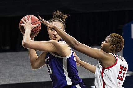 Mar 11, 2021; MO, Kansas City, USA; Kansas State Wildcats center Ayoka Lee (50) controls the ball against Texas Tech Lady Raiders center Khadija Faye (23) in the second half at Municipal Auditorium. Mandatory Credit: Amy Kontras-USA TODAY Sports