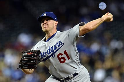 Jun 19, 2021; Phoenix, Arizona, USA; Los Angeles Dodgers relief pitcher Garrett Cleavinger (61) pitches against the Arizona Diamondbacks during the ninth inning at Chase Field. Mandatory Credit: Joe Camporeale-USA TODAY Sports