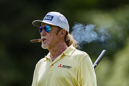 May 29, 2022; Benton Harbor, Michigan, USA; Miguel Angel Jimenez walks off the tee box while smoking a cigar on the thirteenth hole during the final round of the 2022 KitchenAid Senior PGA Championship at Harbor Shores. Mandatory Credit: Raj Mehta-USA TODAY Sports
