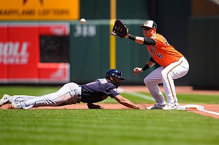 Jun 5, 2022; Baltimore, Maryland, USA; Baltimore Orioles first baseman Ryan Mountcastle (6) receives a throw with Cleveland Guardians shortstop Amed Rosario (1) diving back to the first base bag during the first inning at Oriole Park at Camden Yards. Mandatory Credit: Gregory Fisher-USA TODAY Sports