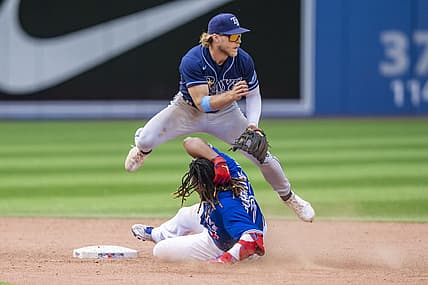 Jul 3, 2022; Toronto, Ontario, CAN; Toronto Blue Jays first baseman Vladimir Guerrero Jr. (27) slides into second base against Tampa Bay Rays shortstop Taylor Walls (6) during the ninth inning at Rogers Centre. Mandatory Credit: Kevin Sousa-USA TODAY Sports
